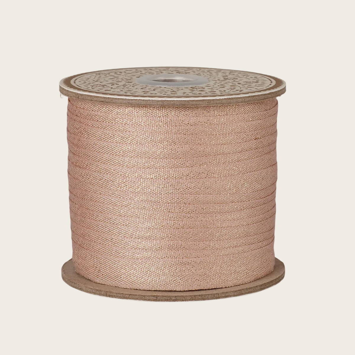 A large spool of metallic rose gold ribbon 