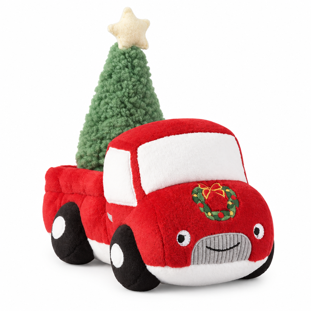 A plush red Christmas car toy with a green Christmas tree in it's bed and a small wreath on the front