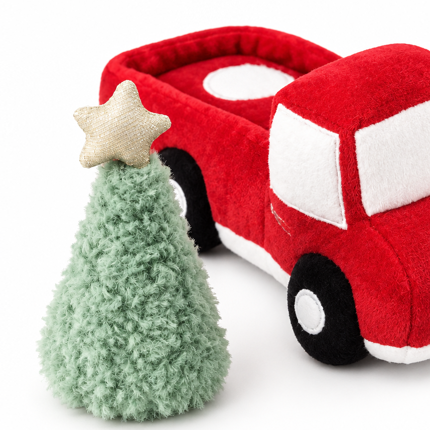 A plush toy set featuring a red fire truck and a small green Christmas tree with a gold star topper.