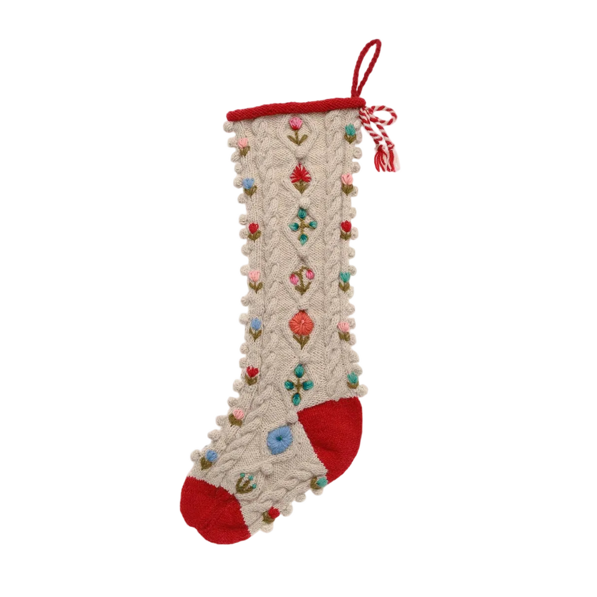 A cream-colored knit Christmas stocking with red trim, a red toe and heel, and colorful embroidered floral motifs, shown on a white background with a black surrounding frame.