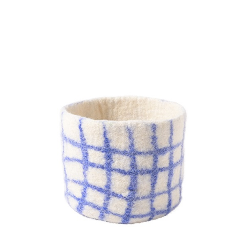 Small woven basket with blue and white checkered pattern on a white background