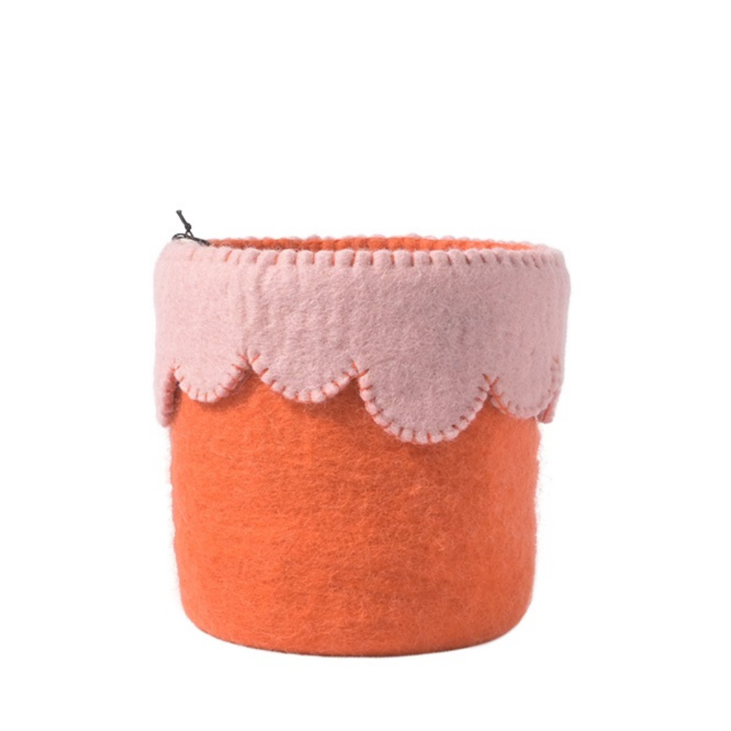 Pink and orange felt basket on a white background
