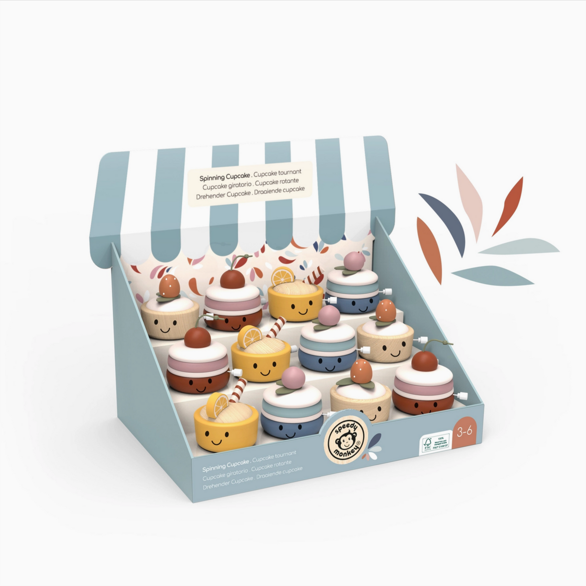 Set of toy cupcakes in a striped packaging box on a white background