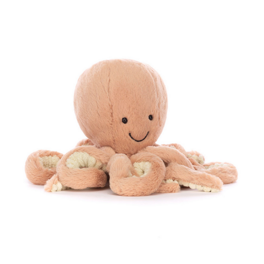 A plush toy resembling an apricot-colored octopus with a smiling face and glossy eyes.
