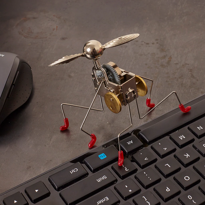 Metal toy figure with propeller on a keyboard