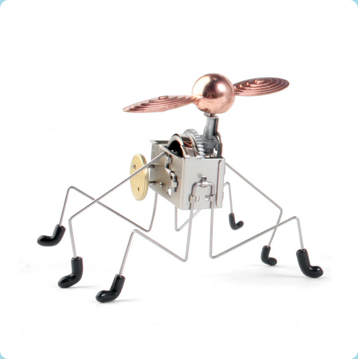 Metallic insect figure with propeller on a white background