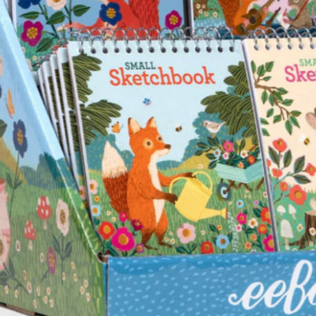Display of small sketchbooks with animal illustrations and 'eeboo' branding.
