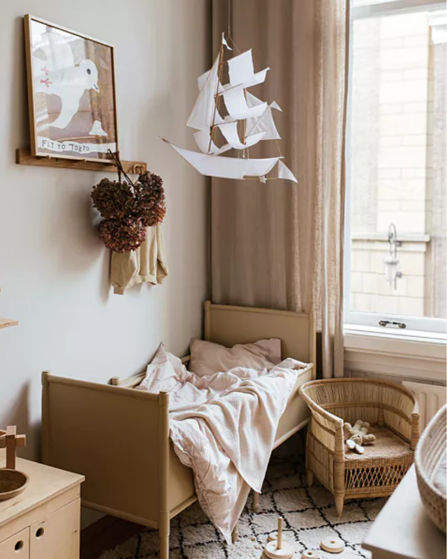 Children's bedroom with a bed, toys, and decorative elements.