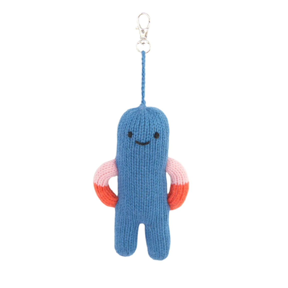 Blue knitted keychain with a smiley face and pink rings on a white background