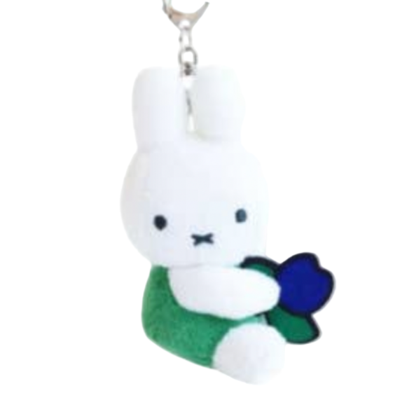Plush keychain of a white rabbit character with a green outfit and blue flower, held by a chain.