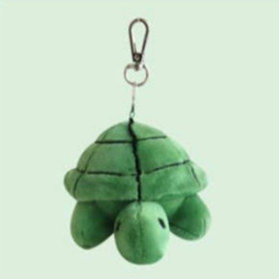 Green plush turtle keychain on a light green background