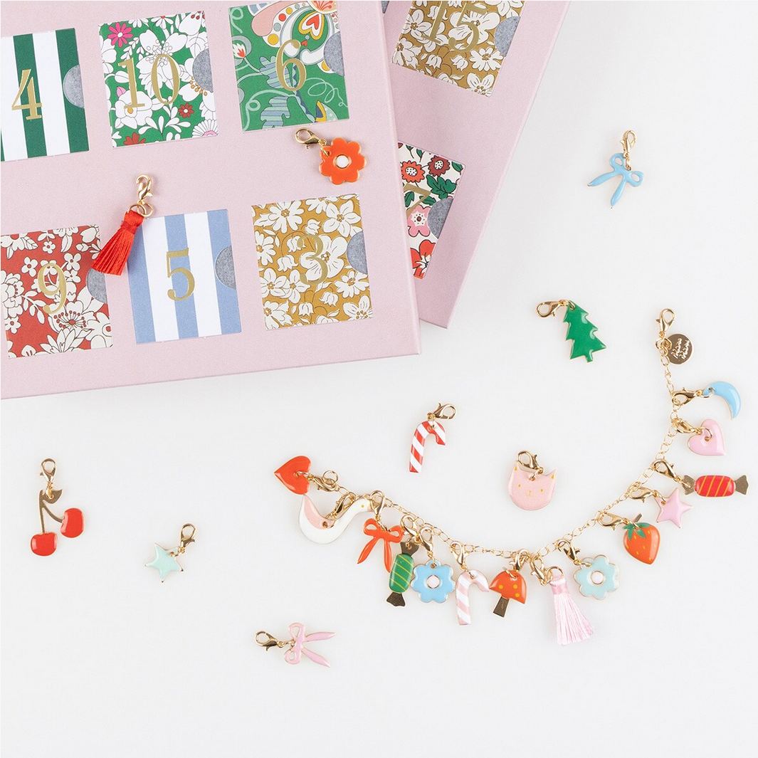 Colorful charm bracelet with various charms on a white background