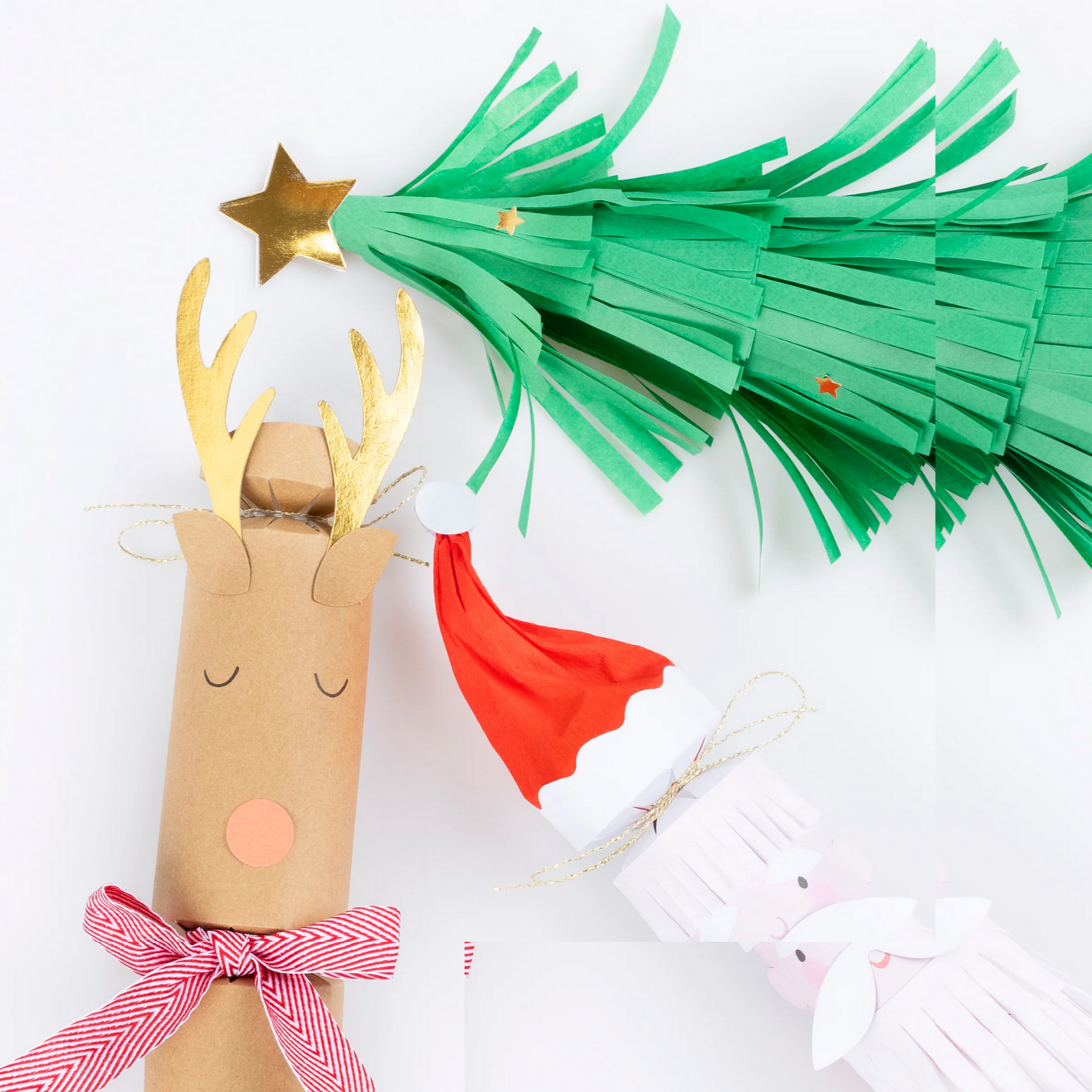 Handmade reindeer and Christmas tree decorations on a white background