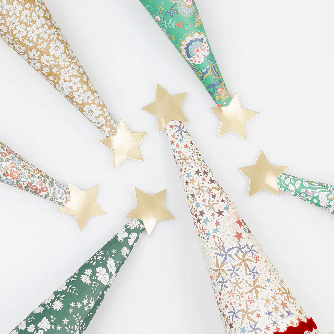 Decorative paper cones with floral patterns and gold stars on a white background