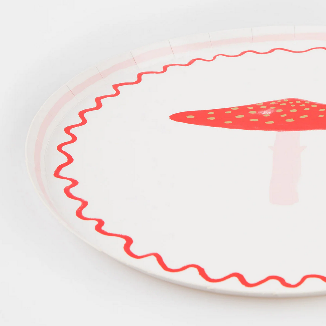 White plate with red wavy edge and strawberry design on a white background