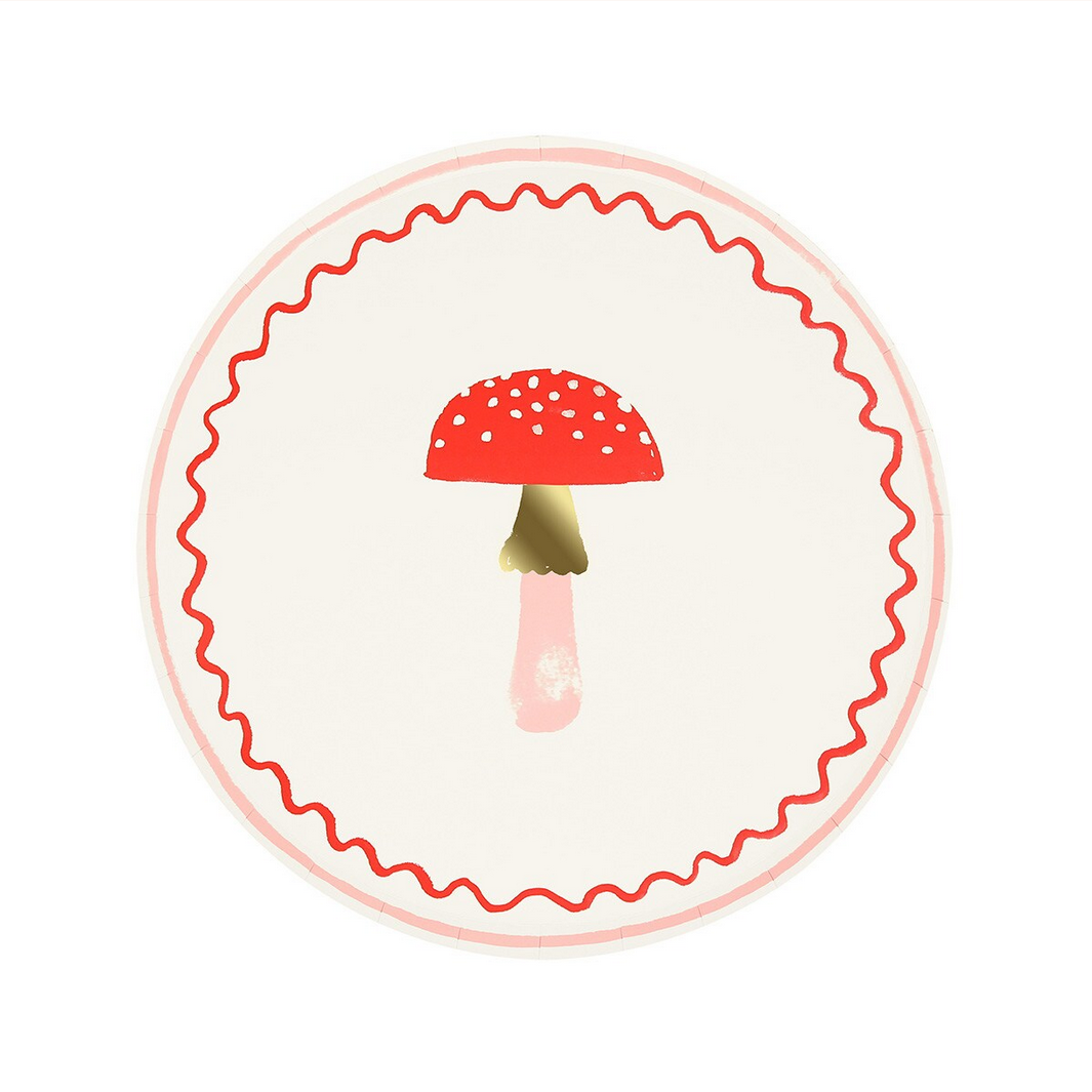 Round plate with a red mushroom design on a white background