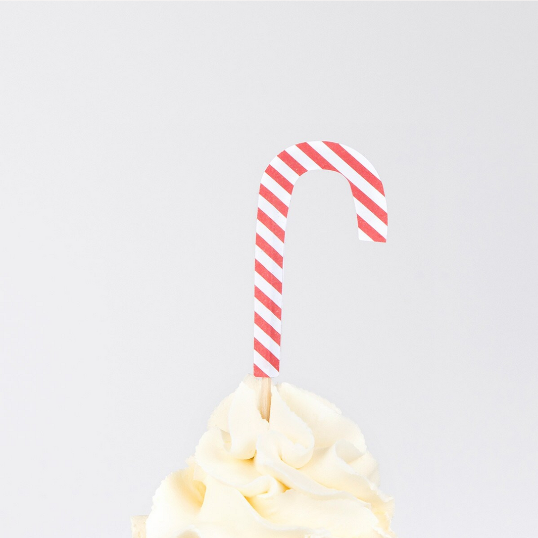 Cupcake with a candy cane on a white background