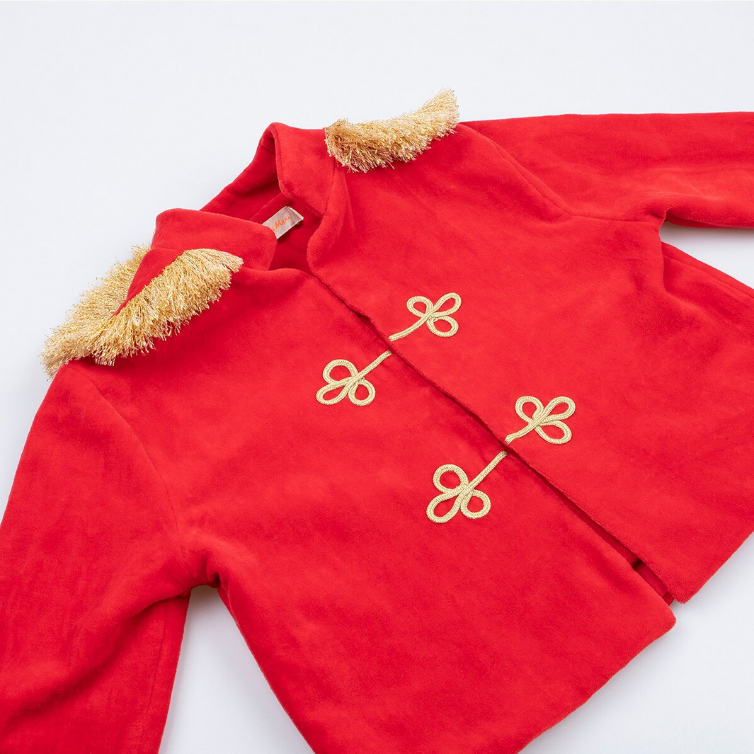 Red outfit with gold buttons and trim on a white background