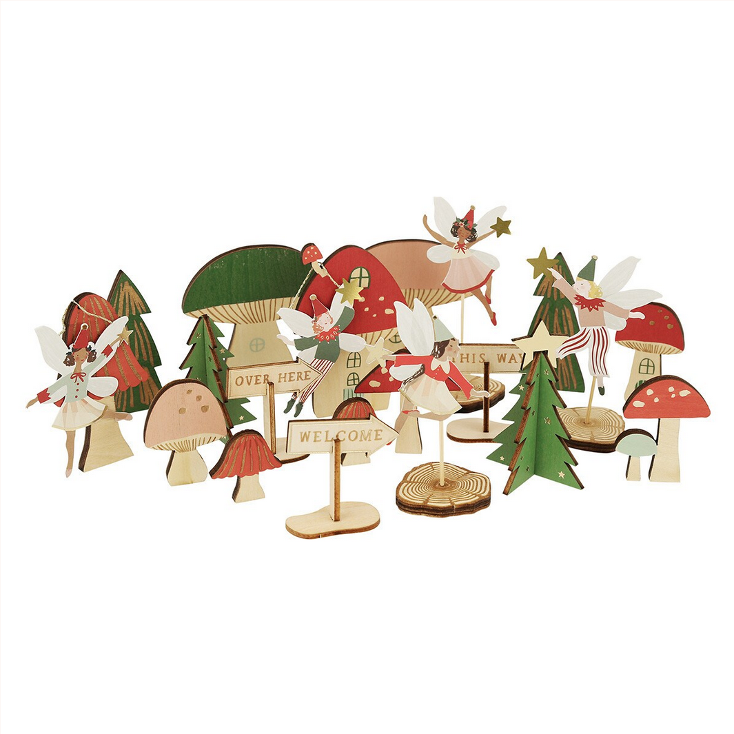 Set of wooden Christmas decorations including trees, houses, and fairies on a white background