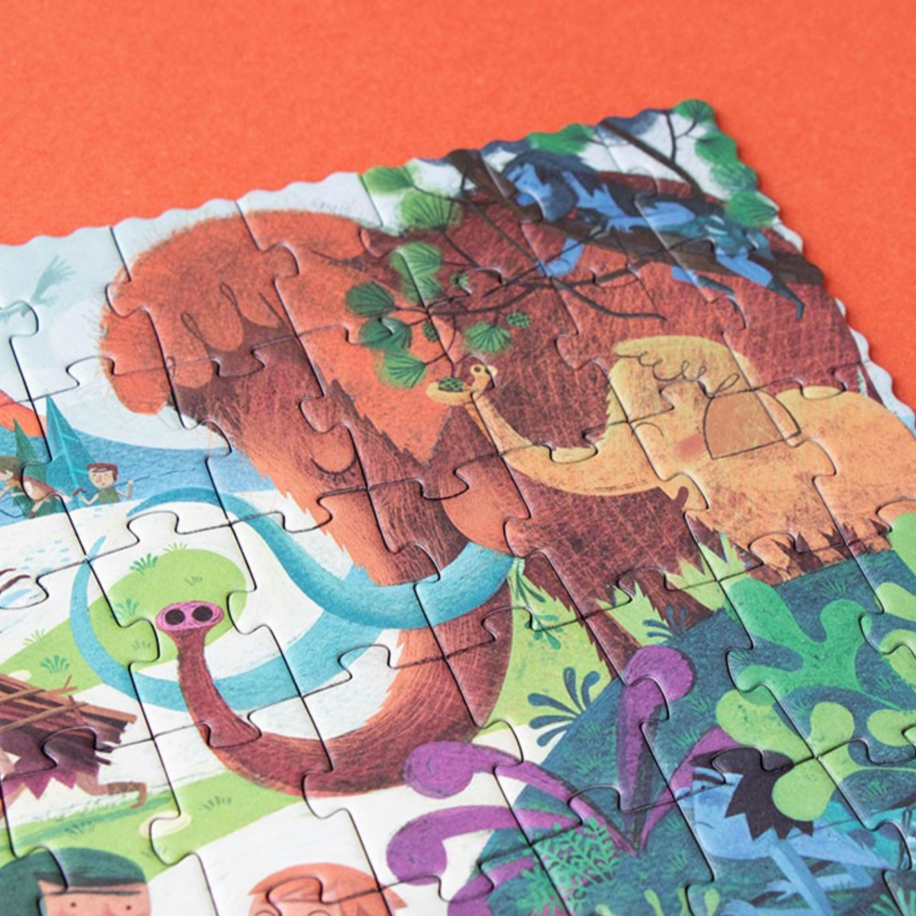 Jigsaw puzzle with a colorful jungle scene on an orange background