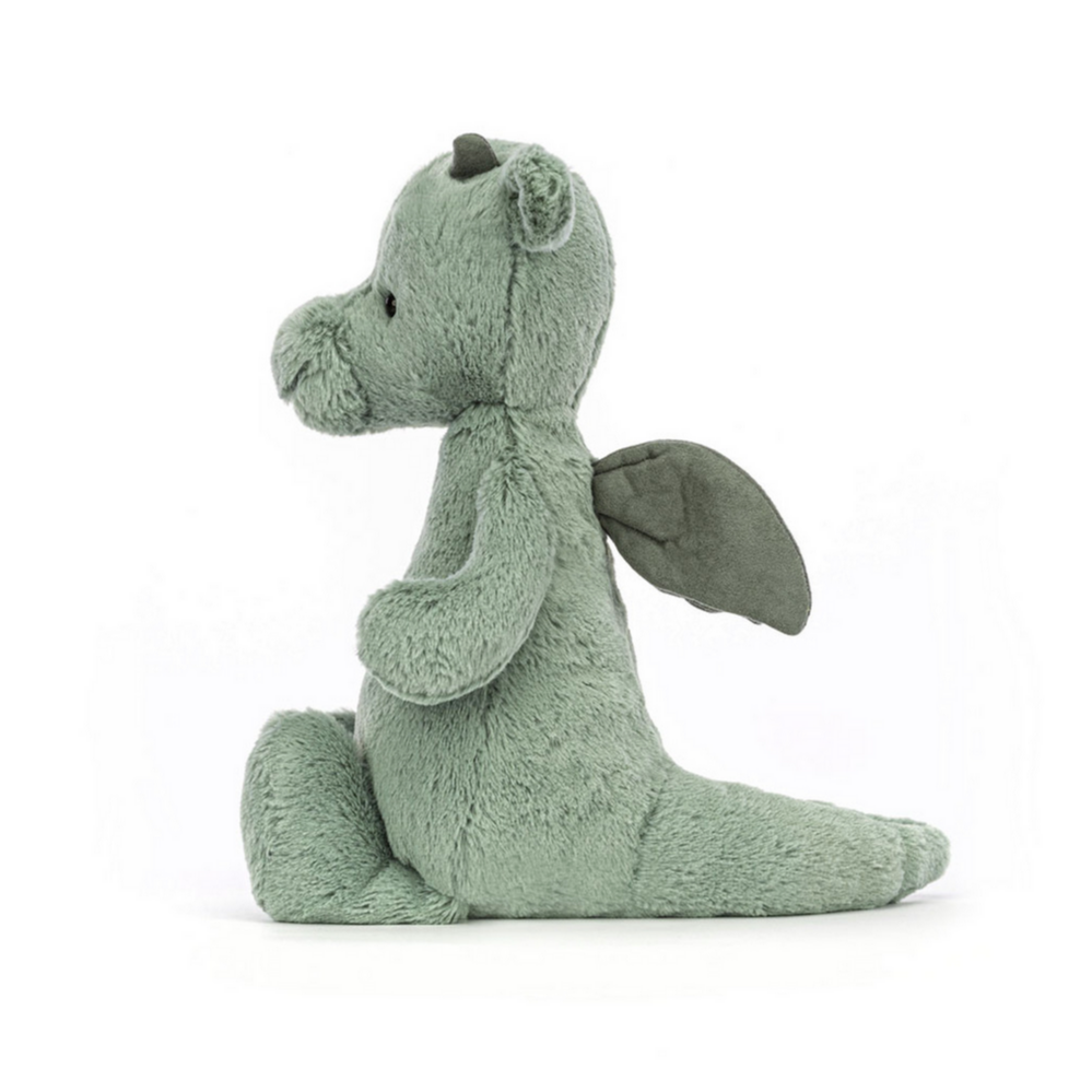 Green plush dragon toy on a white background