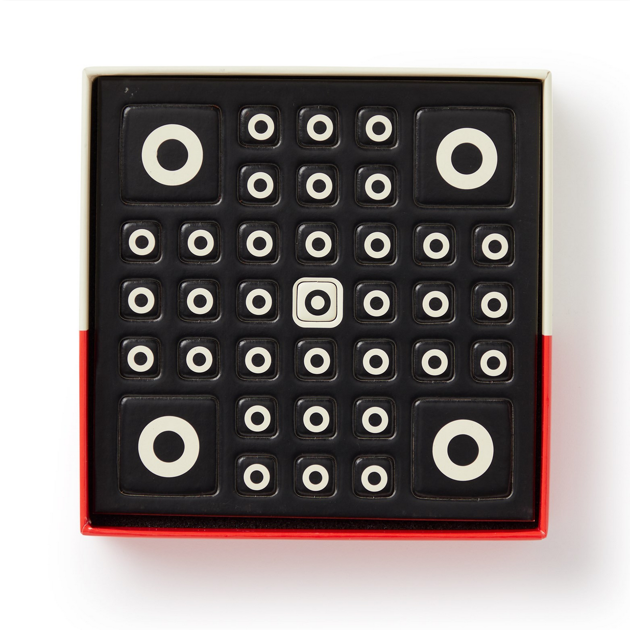 Set of black and white patterned tiles in a box on a white background