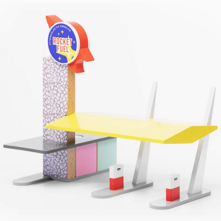 Toy gas station with a yellow fuel pump and 'Rocket Fuel' sign on a white background