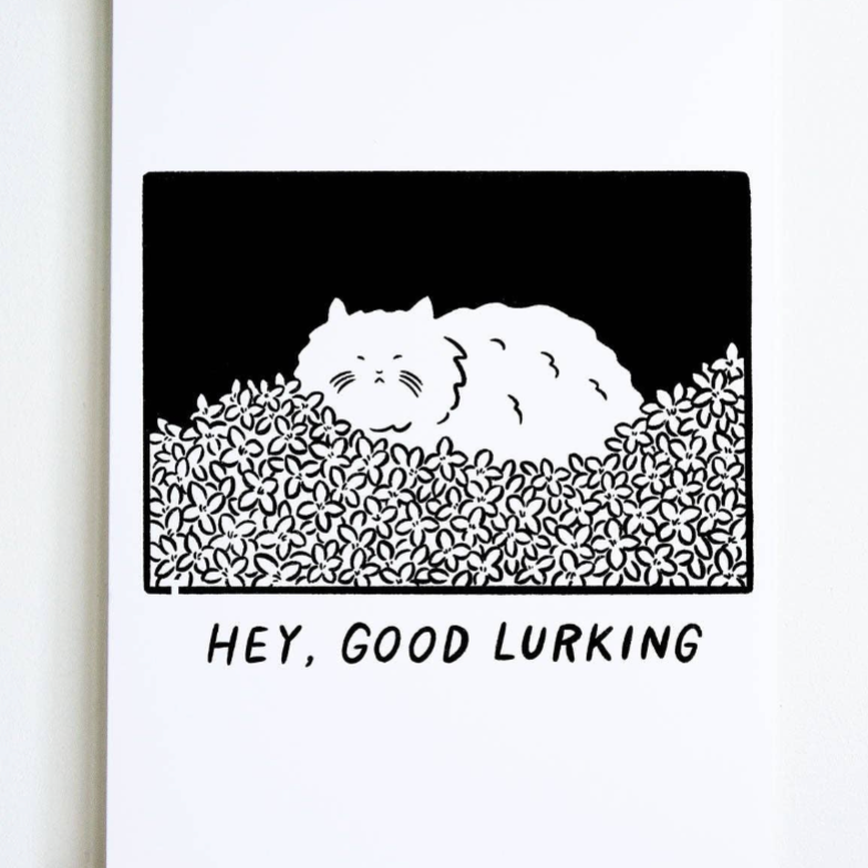 Framed artwork with a black and white illustration of a bear and text 'HEY, GOOD LURKING' on a white background.