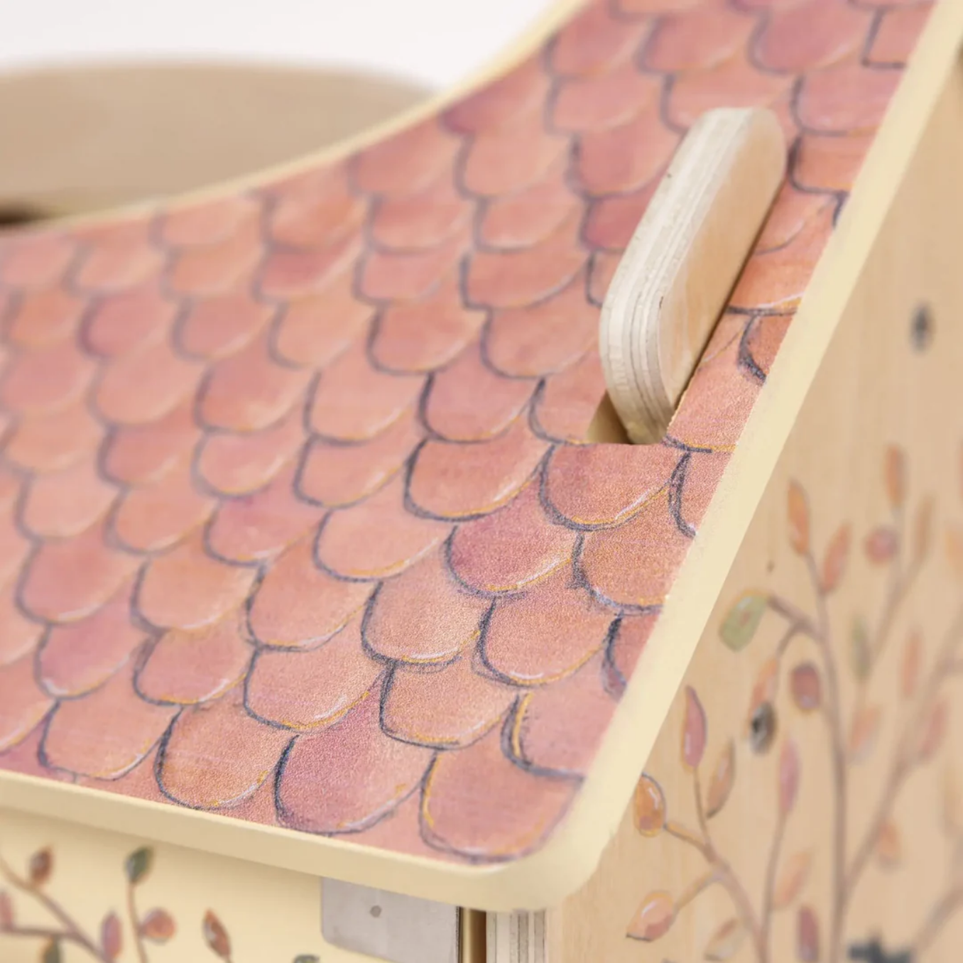Close-up of a wooden product with pink scale-like pattern