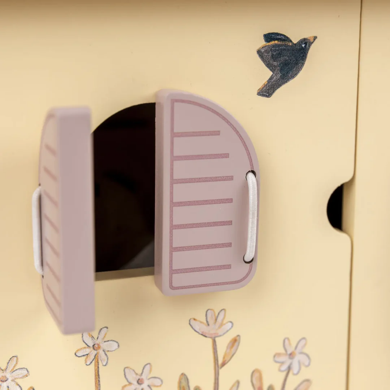 Birdhouse with a pink door on a beige background