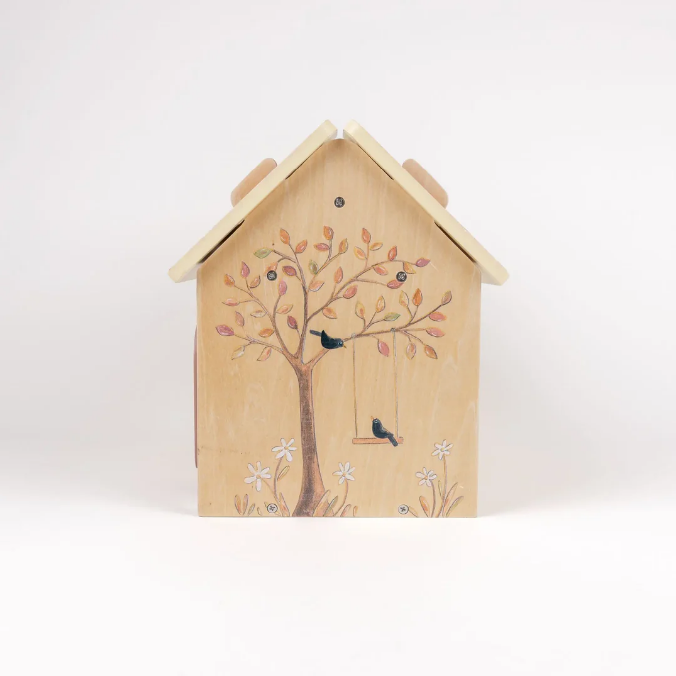 Wooden dollhouse with a tree and birds design on a white background