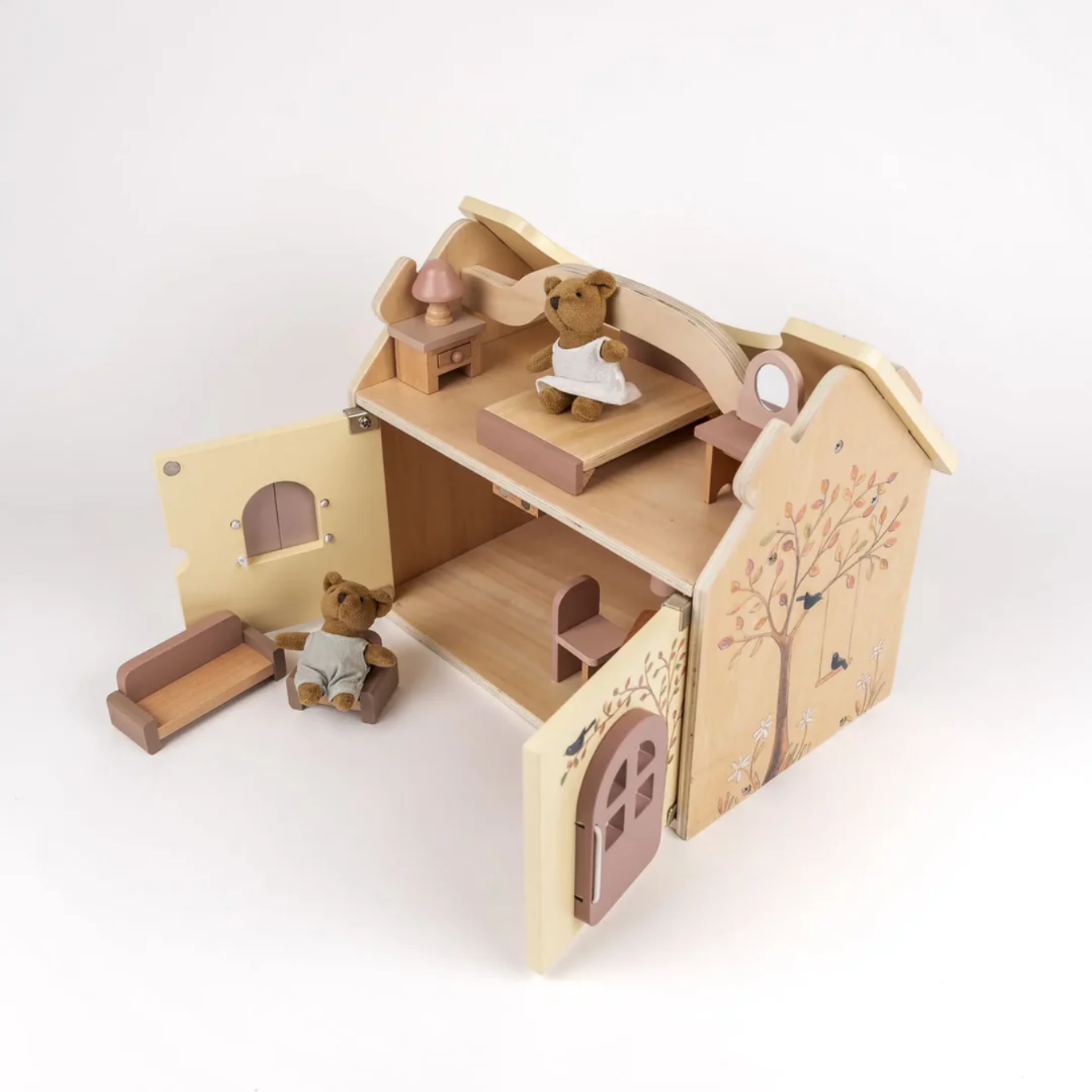 Wooden toy house with teddy bears on a white background