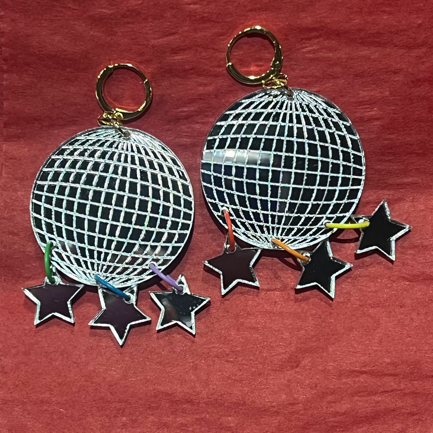  disco ball keychain with stars on a red background