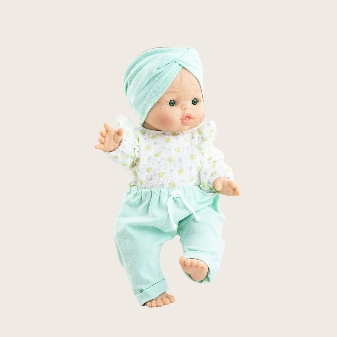 Baby doll in light blue outfit on a white background