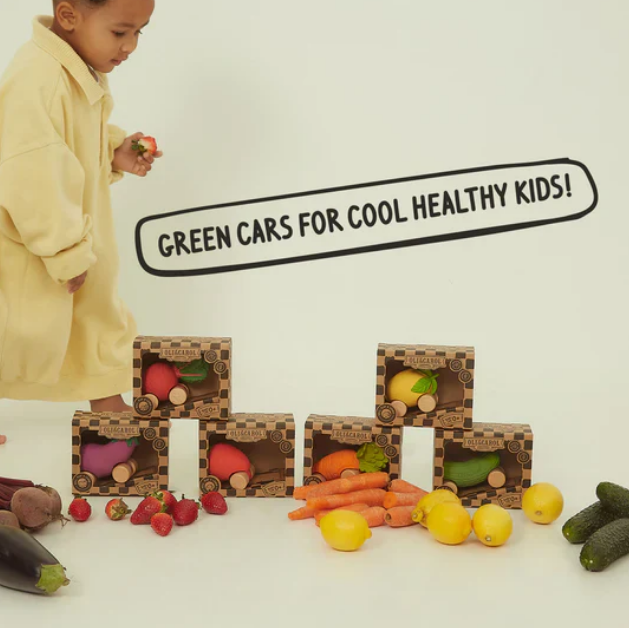 Child playing with toy vegetables on a white background with text 'Green Cars for Cool Healthy Kids'.