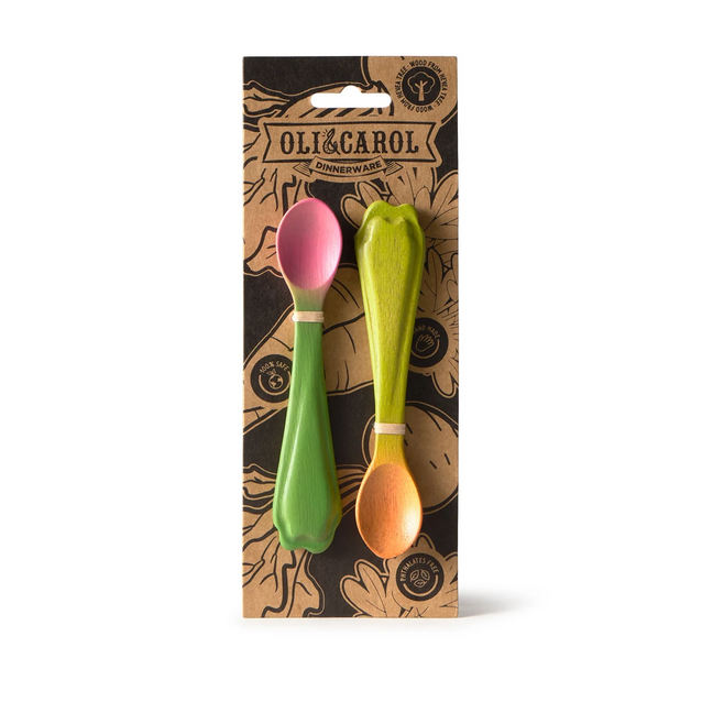 Two colorful spoons in a package with 'Oli & Carol' branding on a white background.