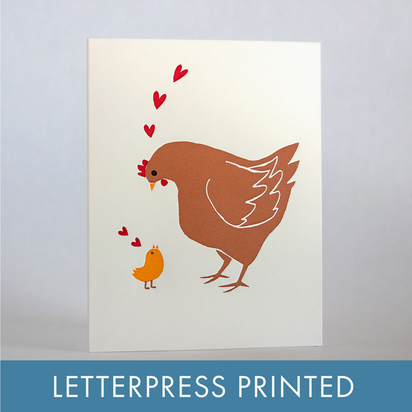Letterpress printed card with a brown hen and orange chick on a light background