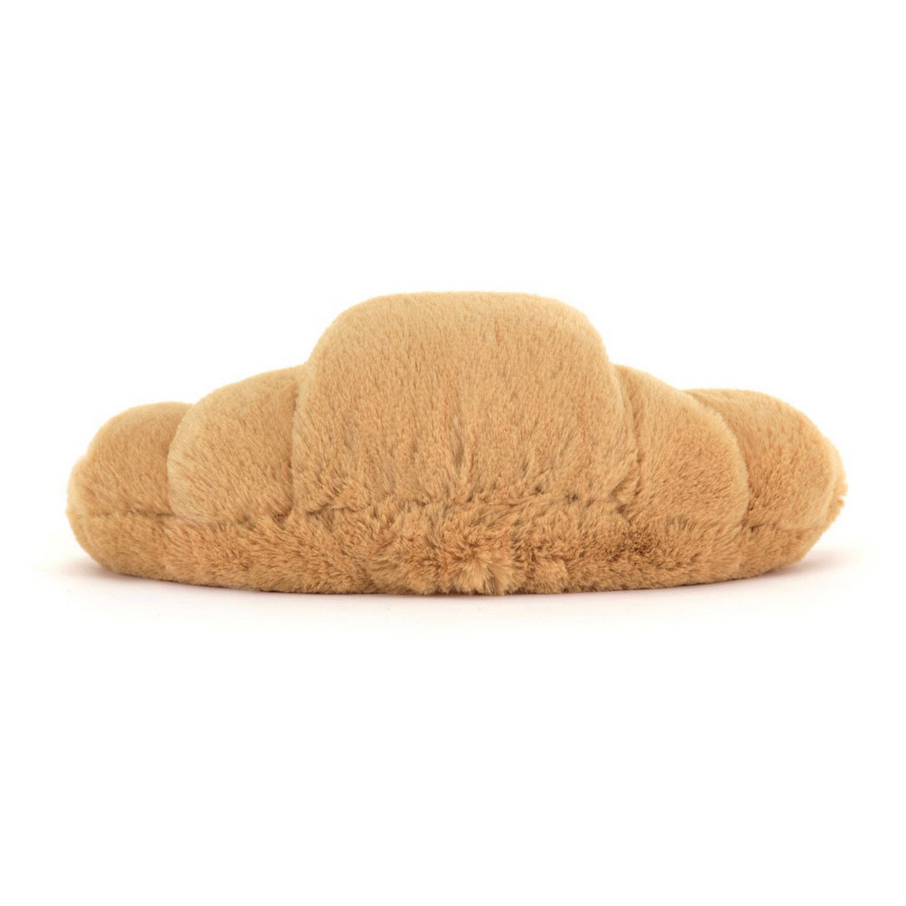 Plush croissant-shaped toy on a white background