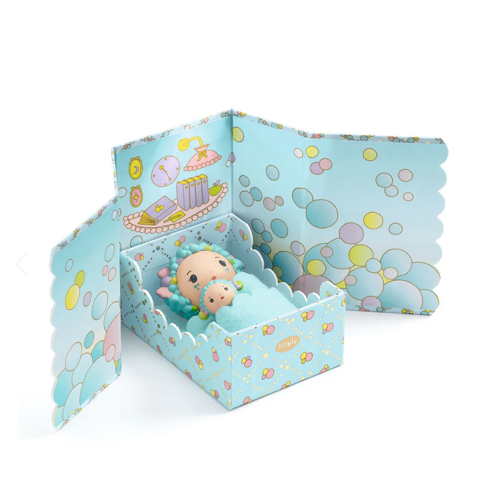 Toy figure in a decorative box with bubble design on a white background
