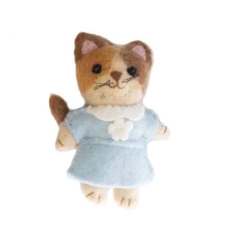 Stuffed toy cat in a blue dress on a white background