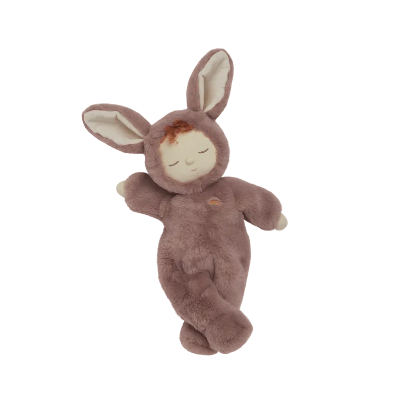 Stuffed toy resembling a baby in a bunny costume on a beige background
