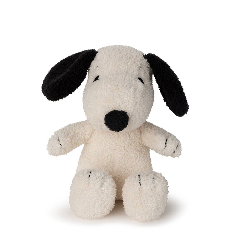 Stuffed dog toy with black ears and nose on a white background