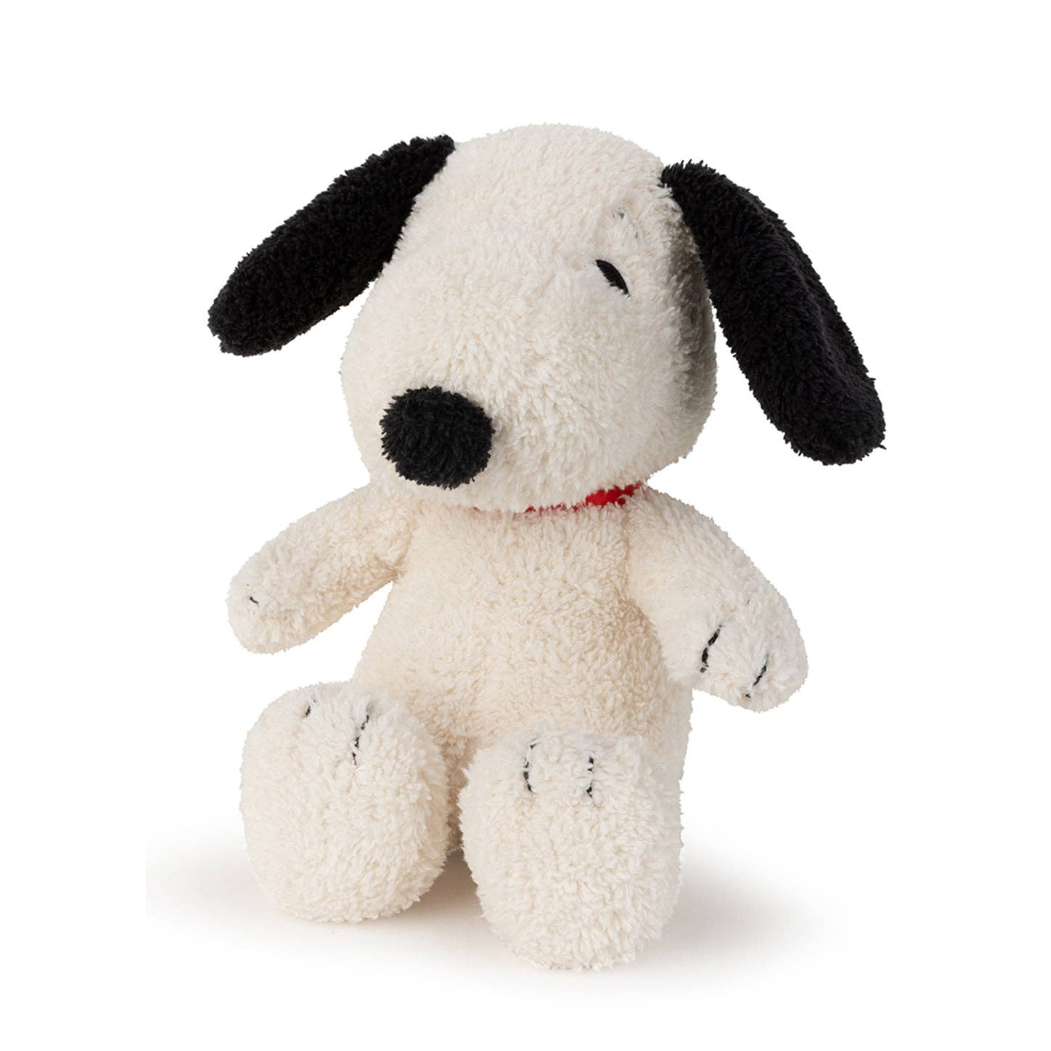 Stuffed dog toy with black ears and nose on a white background