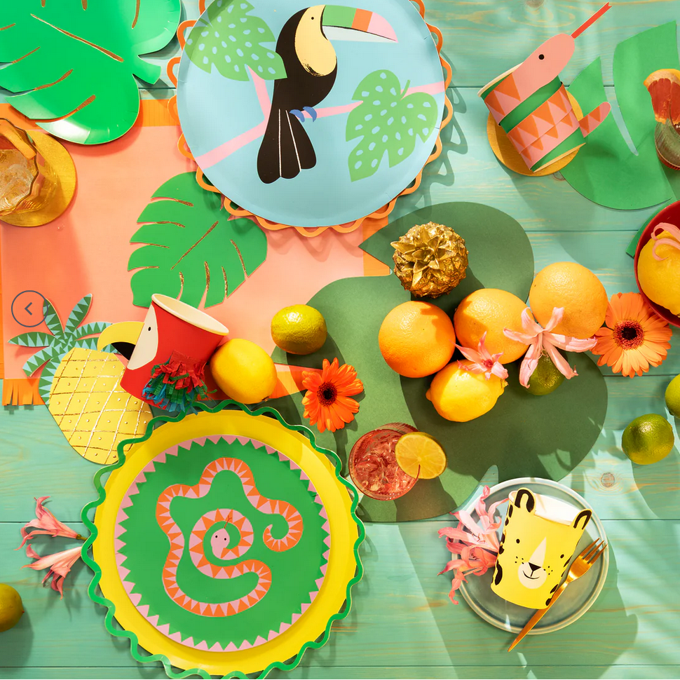 Colorful children's tableware with animal designs on a green background