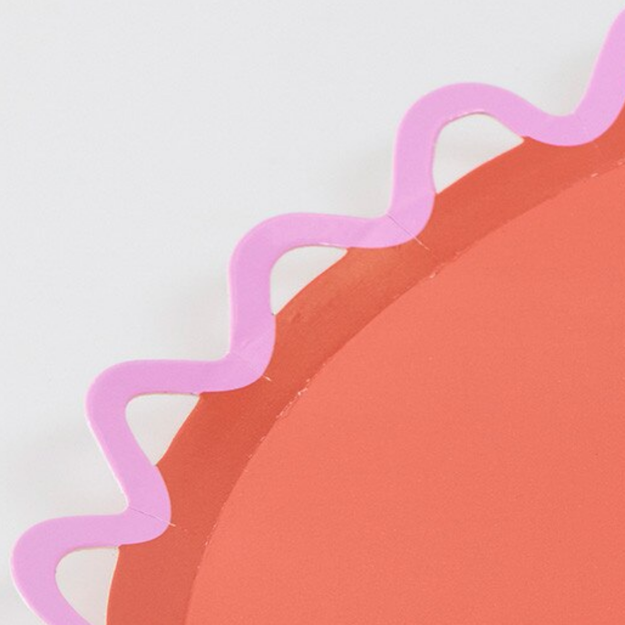 Abstract design with a pink wavy line on a red circle against a light gray background
