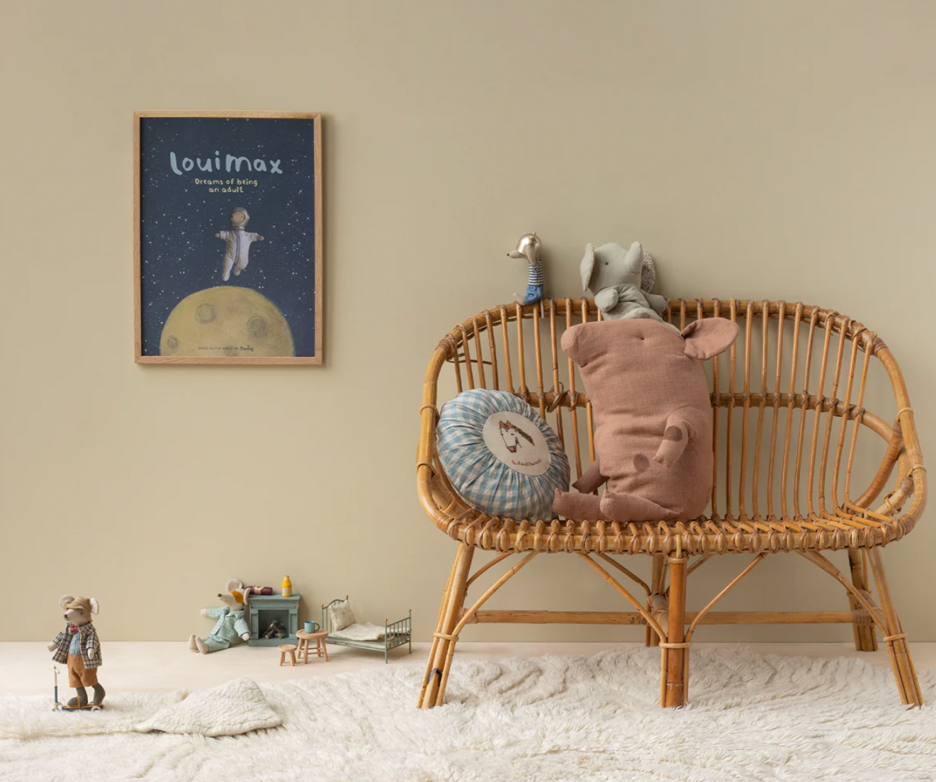 Children's room with a wicker bench, stuffed animals, and a framed picture on the wall.