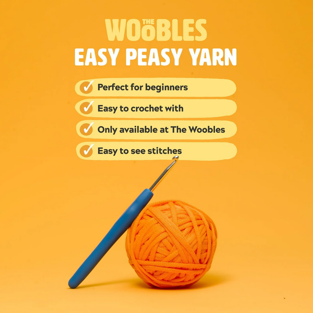 Orange ball of yarn with a blue crochet hook on an orange background, featuring text about 'Woobles Easy Peasy Yarn'.