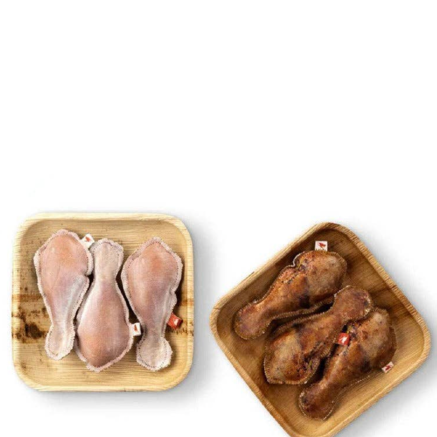 Two wooden trays with raw chicken pieces on a white background