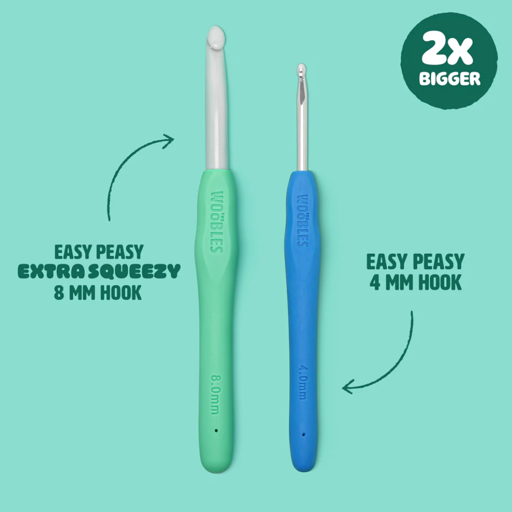 Two crochet hooks, one green and one blue, on a light blue background with text indicating size and brand.