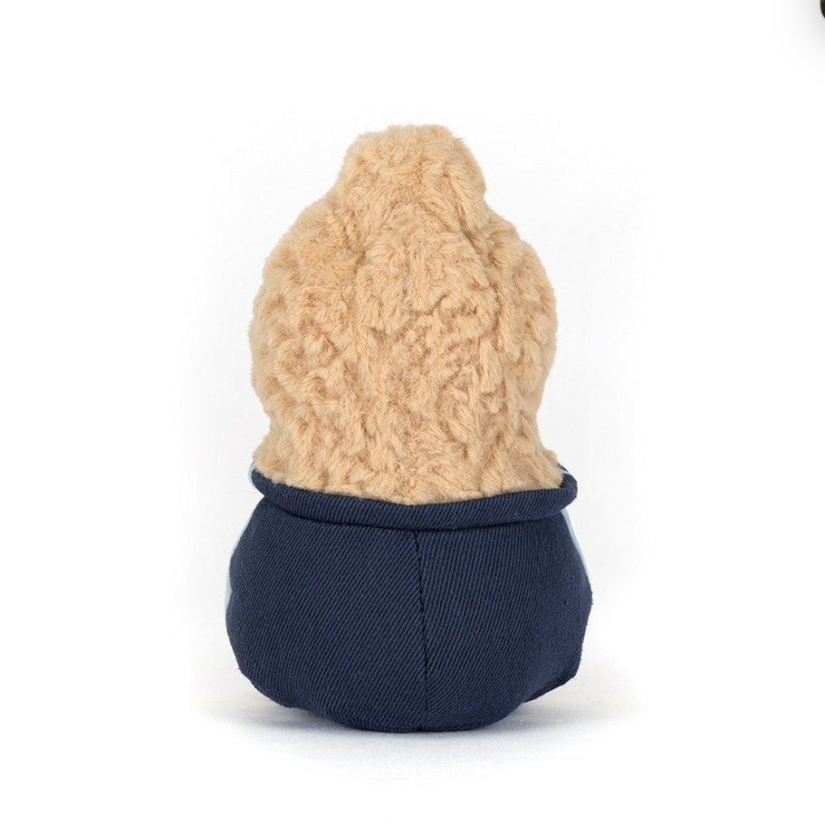Small plush toy with a textured beige top and navy blue bottom on a white background